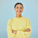 Smile, portrait and woman in studio with arms crossed, fashion and youth mindset on blue background. Confidence, pride and happy face of girl with beauty, gen z style and excited positive attitude.