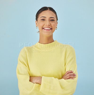 Buy stock photo Smile, portrait and woman in studio with arms crossed, fashion and youth mindset on blue background. Confidence, pride and happy face of girl with beauty, gen z style and excited positive attitude.