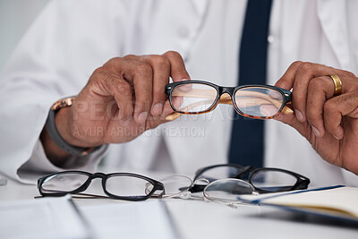 Buy stock photo Hands, man and optician with choice of glasses for vision, eyesight and prescription eye care. Closeup of doctor, optometrist and decision for frame, lens and eyewear of optical healthcare assessment