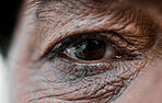 Eye, vision and wrinkles with a senior person closeup for sad emotion, pain or grief on an expressive face. Healthcare, depression or loss with an elderly adult looking nostalgic during retirement