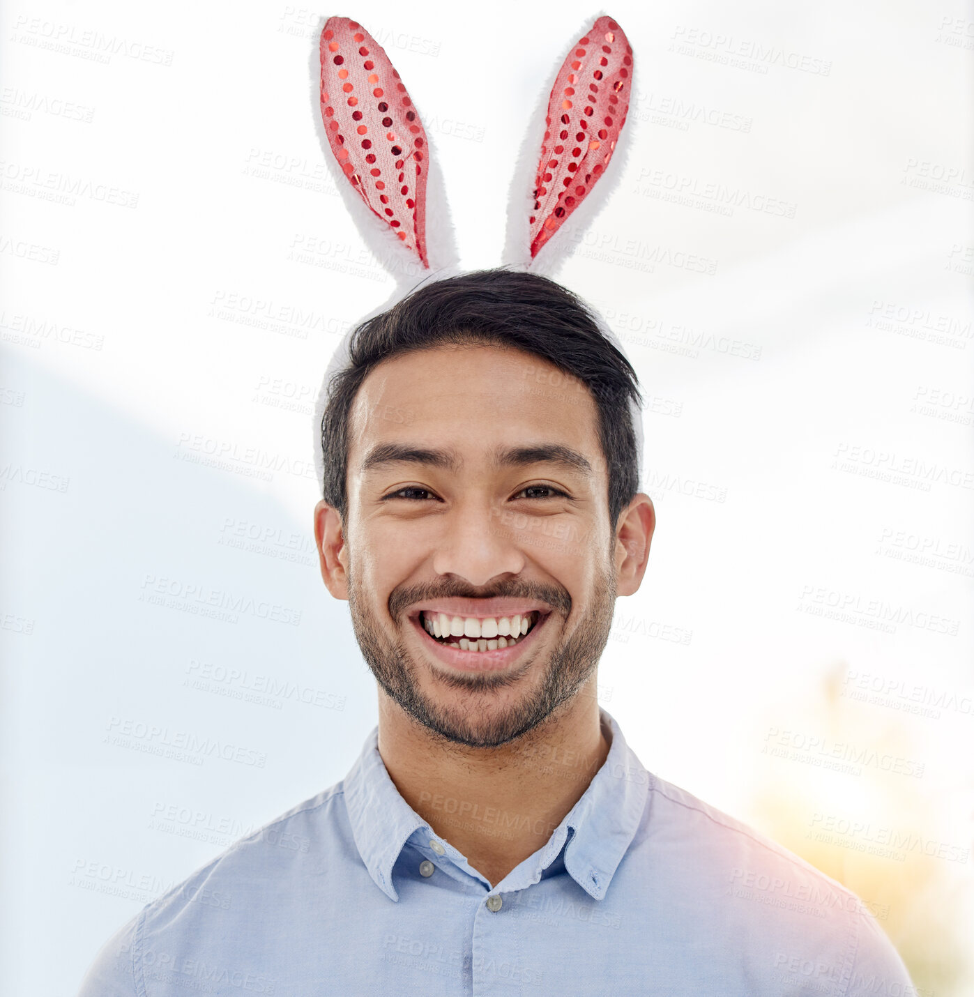 Buy stock photo Bunny ears, holiday and business man portrait with a smile from easter and creative job pride. Celebration, happy and male professional from Spain feeling silly and goofy with comedy hat at office