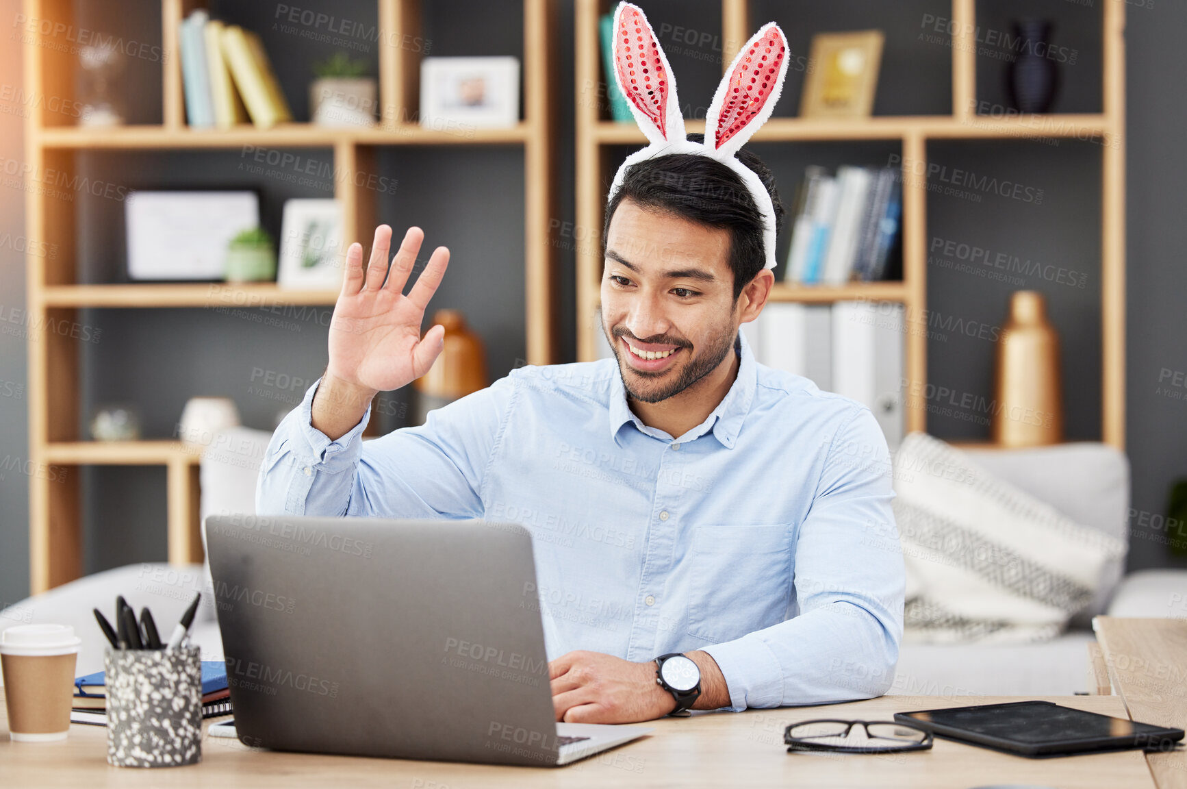 Buy stock photo Easter bunny, ears and man on online meeting at home with computer screen and greeting. Remote work, holiday and rabbit costume in virtual call in house for digital education class with male teacher