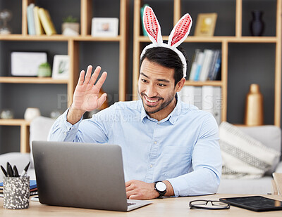 Buy stock photo Businessman, bunny ears and video call at home in online meeting with computer screen and wave greeting. Remote work, holiday and rabbit costume for digital education class with male teacher at house