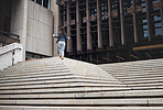 Walking, city and business woman on steps with coffee for morning commute, journey and travel. Professional, worker and female person with drink for career, work and job in urban town by building
