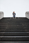 Business woman, city stairs and thinking with sitting, vision and ideas for future, career or life goal. Entrepreneur, dream and brainstorming with choice, decision or mindset in metro with low angle