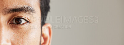 Buy stock photo Eye banner, portrait and man for optometry, vision and mockup for healthcare advertising. Half face, closeup and person on a backdrop with space for anatomy, focus and marketing of contact lenses