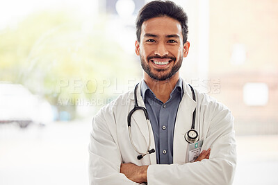 Buy stock photo Portrait, smile and asian man doctor with arms crossed in hospital with stethoscope for consulting on blurred background. Happy, face and male healthcare expert proud of clinic, service or help