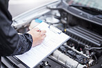 Checklist, car insurance and man writing on documents for compliance, maintenance and engine control. Vehicle, inspection and hand of male mechanic with paper form for information, note and claim