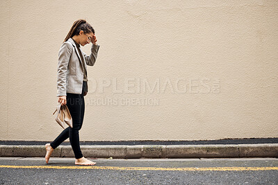 Buy stock photo Tired, sad and business woman in city for thinking, fatigue and headache. Burnout, mental health and mistake with female employee walking in street for depression, failure and crisis with wall mockup