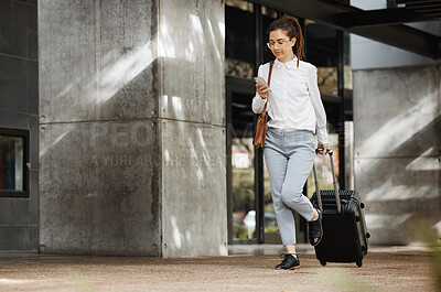 Buy stock photo Phone, travel and luggage with a business woman walking in an airport parking lot outdoor in the city. Mobile, suitcase and commute with a young female employee on an international trip for work