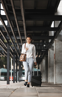 Buy stock photo Phone, travel and luggage with a business woman in an airport parking lot walking outdoor in the city. Mobile, suitcase and commute with a young corporate employee on an international trip for work