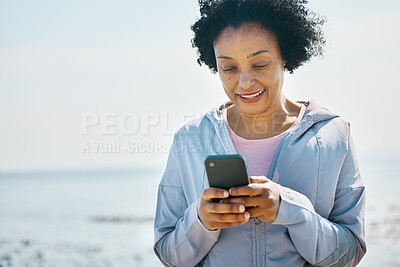 Buy stock photo Fitness, beach and senior woman with smartphone, typing and social media with connection, network and smile. Happy person, pensioner and old lady with a cellphone, happiness and contact with message