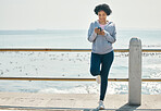 Fitness, beach and woman with a cellphone, typing and social media with network, sports and smile. Happy person, athlete and seaside with a smartphone, internet connection and contact with exercise