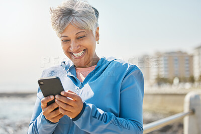 Buy stock photo Fitness, beach and senior woman with cellphone, happiness and social media with network, email and smile. Happy person, pensioner and elderly lady with a smartphone, seaside and contact with message