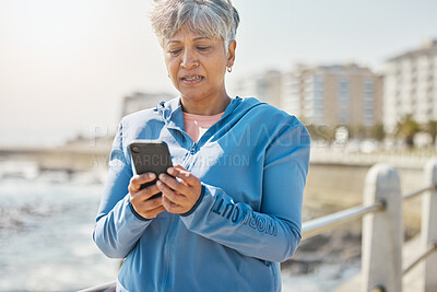 Buy stock photo News, phone and fitness with old woman at beach for running, workout and results. Network, communication and contact with female runner training in nature for technology, sports and mobile app