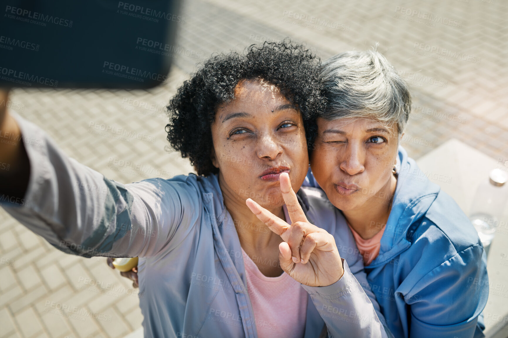 Buy stock photo Senior women, selfie and peace, hands and wink in a city for travel, fun and chilling on the weekend outdoor. Face, friends and old ladies pose for profile picture, photo or traveling memory in town