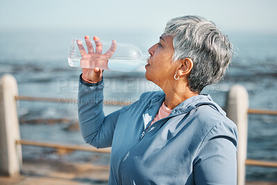 Buy stock photo Outdoor, fitness or senior woman drinking water for hydration, wellness and thirsty on beach run, training or exercise. Bottle, runner or elderly person refresh with cold liquid on retirement workout
