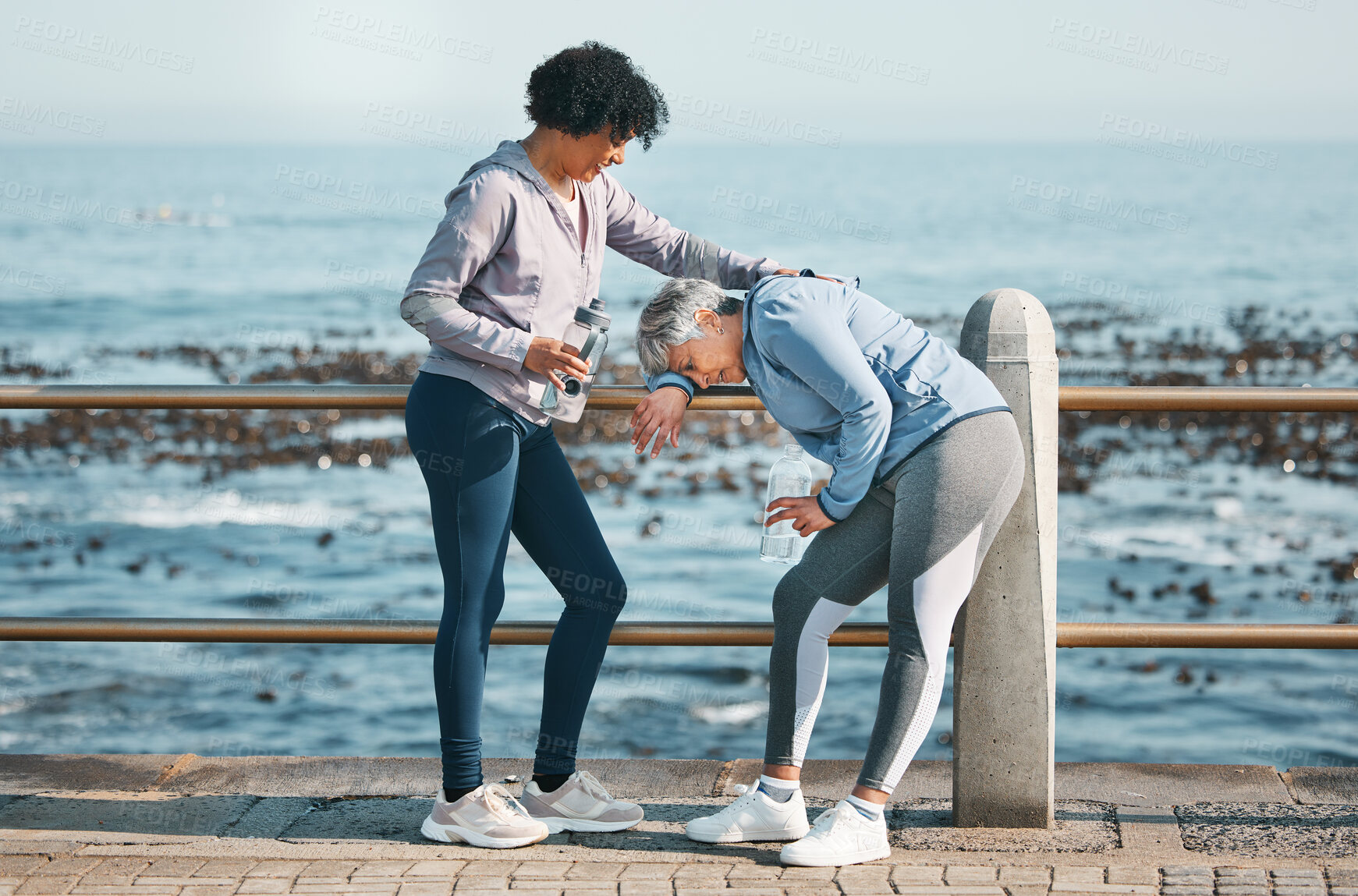 Buy stock photo Tired, running and senior friends by the ocean for fitness, exercise and workout. Runner, mature people with sport outdoor on a beach promenade path together for wellness and health on a break