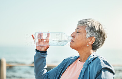 Buy stock photo Senior woman, drinking water and health with fitness, hydration and break during workout outdoor. Plastic bottle, liquid and wellness with female athlete at the beach, exercise and training with h2o