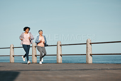 Buy stock photo Senior, fitness and women friends at the beach for running, bond and morning cardio in nature together. Ocean, workout and elderly female runners happy, talking and enjoy fresh air, run and training