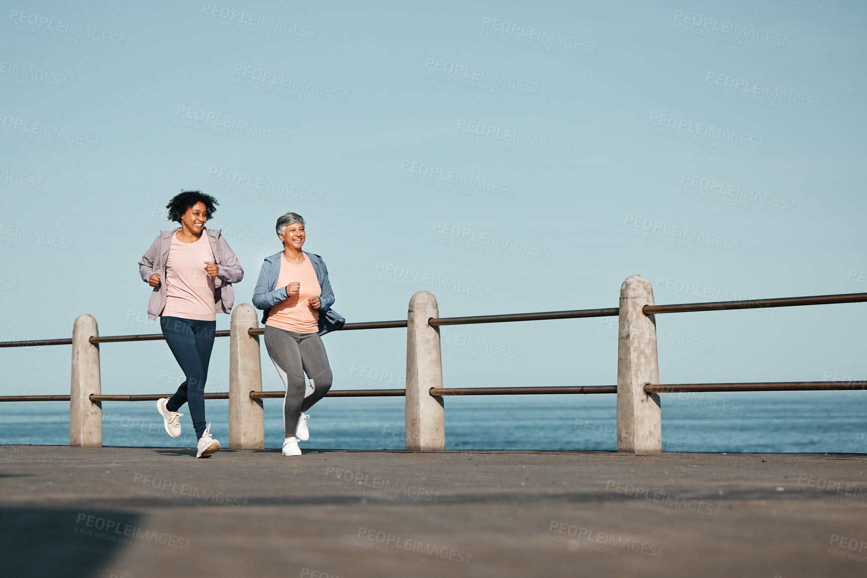 Buy stock photo Senior, fitness and women friends at the beach for running, bond and morning cardio in nature together. Ocean, workout and elderly female runners happy, talking and enjoy fresh air, run and training