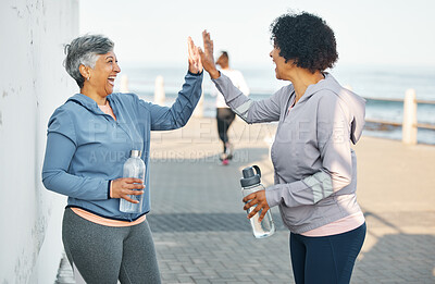 Buy stock photo Fitness, happy and women high five by ocean for healthy lifestyle, wellness and cardio on promenade. Sports, friends and female people celebrate on boardwalk for exercise, training and workout goals