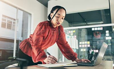Buy stock photo Woman on laptop, research and writing notes, ideas on website for business plan or brainstorming proposal process. Thinking, businesswoman with pen and book on computer, standing in startup office.