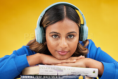 Buy stock photo Woman, student and studio portrait in headphones, books or listen to investing podcast by yellow background. Gen z girl, scholarship or streaming subscription for music app, sound or studying economy