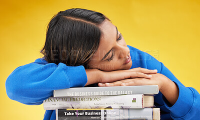 Buy stock photo Woman, student and sleeping with books in studio with burnout, financial education and tired by yellow background. Gen z girl, learning and studying business with fatigue, knowledge and development