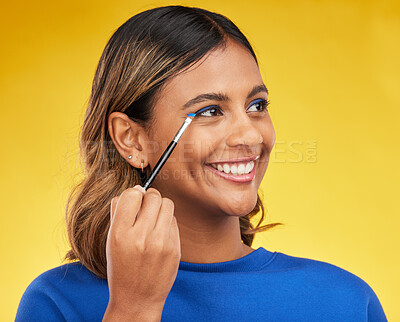 Buy stock photo Woman, makeup and brush with skincare, thinking or self care on a yellow studio background. Female person, smile or model with cosmetic tool, luxury or foundation with mindset, aesthetic or eyeshadow