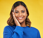 Portrait, smile and skincare with a woman on a yellow background in studio for fashion or cosmetics. Face, makeup and a happy young female model posing indoor in a trendy outfit for clothes style