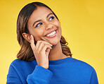 Thinking, happy and young woman in a studio with a dreaming, idea or brainstorming facial expression. Smile, happiness and Indian female model with a planning or decision face by a yellow background.
