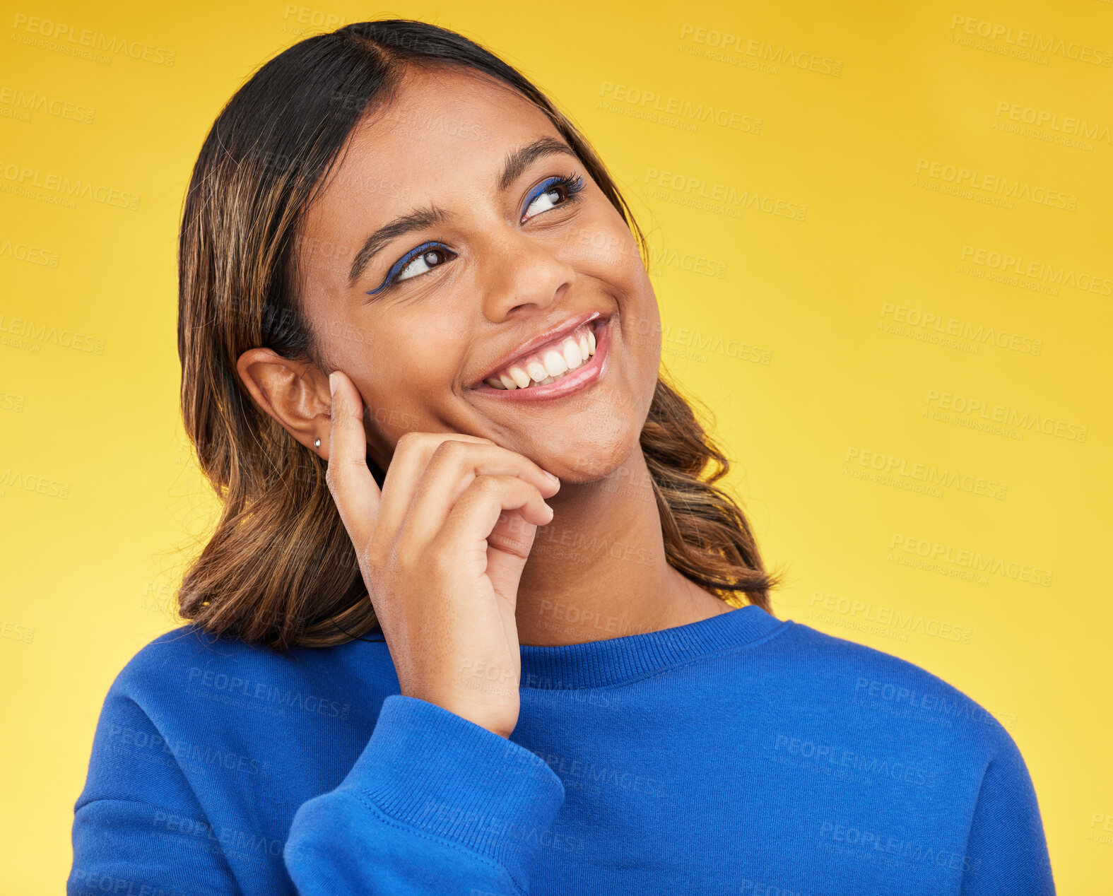 Buy stock photo Thinking, happy and young woman in a studio with a dreaming, idea or brainstorming facial expression. Smile, happiness and Indian female model with a planning or decision face by a yellow background.