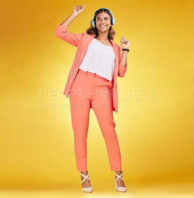 Buy stock photo Woman, headphones and happy dance to music in studio for fashion, freedom and audio energy on yellow background. Indian model, style and dancing to celebration, listening to radio and streaming sound