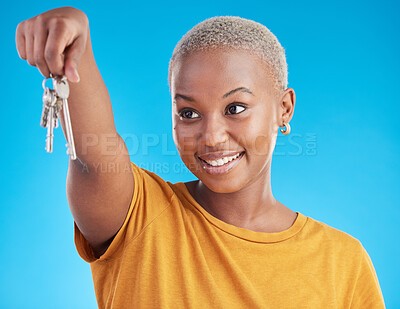 Buy stock photo Happy, new home or black woman with keys in studio for property investment isolated on blue background. Hands, smile or African person excited about loan approval opportunity for dream house gaol