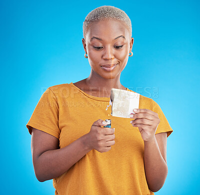 Buy stock photo Woman, burning money and euro bills on fire, flame or financial crisis on studio, blue background and college student. Inflation, increase and banknote of dollar or African customer spending cash