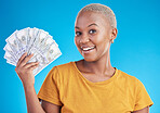 Black woman, cash fan and finance, portrait and happy with prize, loan and dollars isolated on blue background. Money, cashback and lottery win with payment, financial freedom and bills with bonus