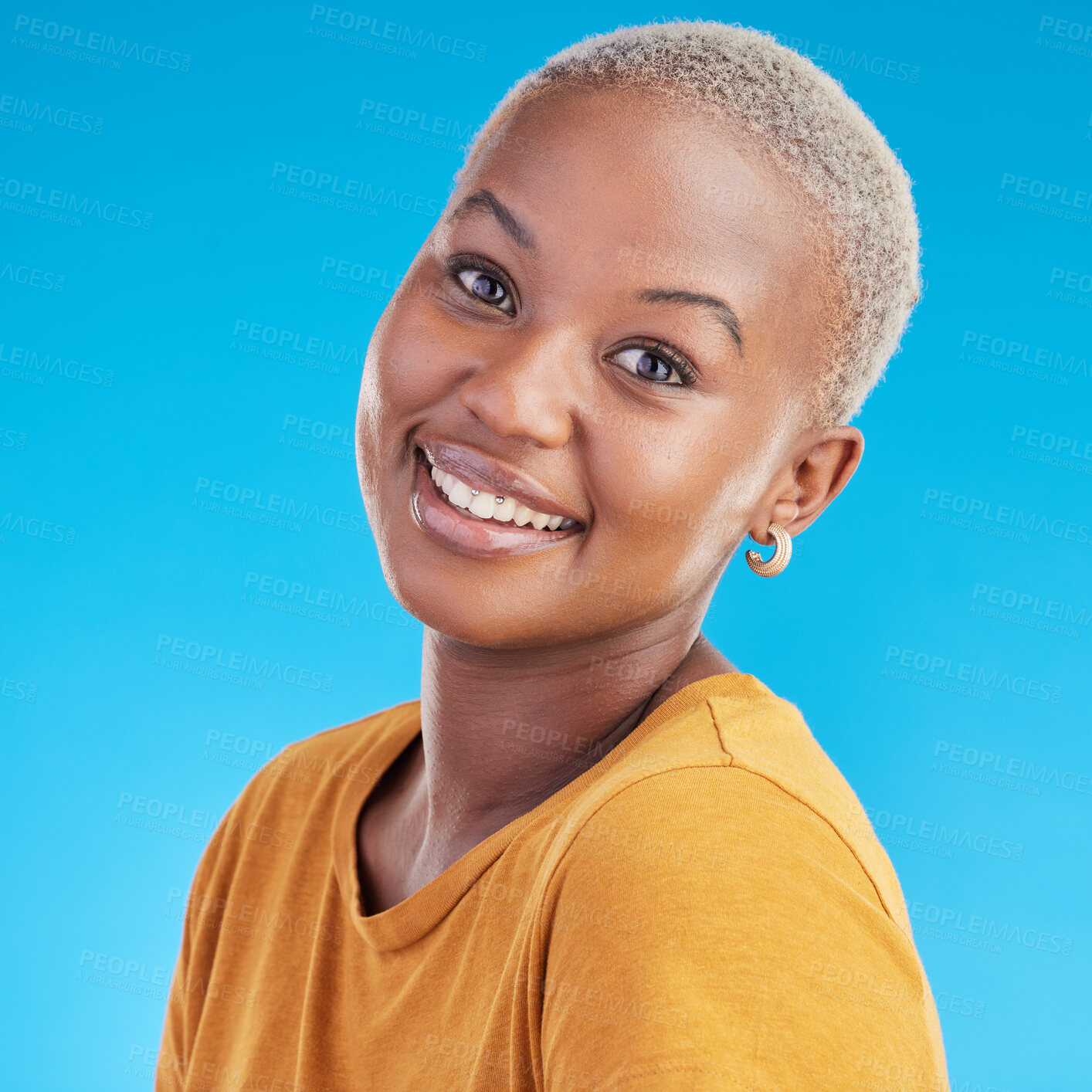 Buy stock photo Black woman, portrait and happy, smile in a studio with youth and positive mindset isolated on blue background. Casual fashion, headshot and African female person, face and t shirt with happiness