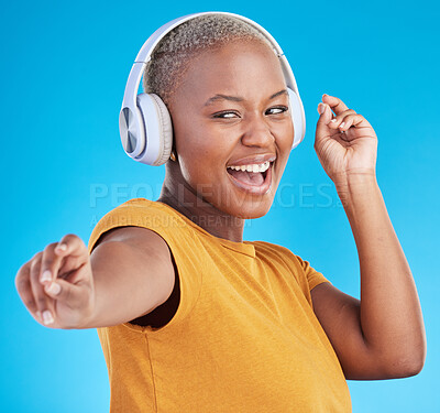 Buy stock photo Black woman, headphones and dance, listen to music and energy with happiness isolated on blue background. Female person, wireless tech and radio with fun, dancer with freedom and streaming in studio