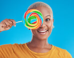 Portrait, cover and black woman with a lollipop, candy and happiness on a blue studio background. Face, happy female person and African model with sugar treats, confectionary and cheerful girl