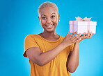 Portrait, present and happy black woman with box in studio isolated on a blue background for giveaway. Face, smile and African person with gift for party, celebration of holiday or birthday package