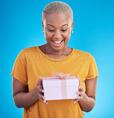 Buy stock photo Smile, gift and excited black woman with box in studio isolated on a blue background. Package, happy and African person with present for party, celebration of holiday or birthday for giveaway prize
