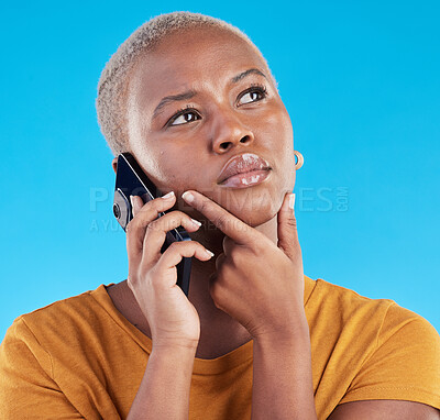 Buy stock photo Black woman, phone call and thinking of college decision, listening to news or feedback on blue, studio background. Serious person or student on mobile communication with doubt, choice or idea emoji