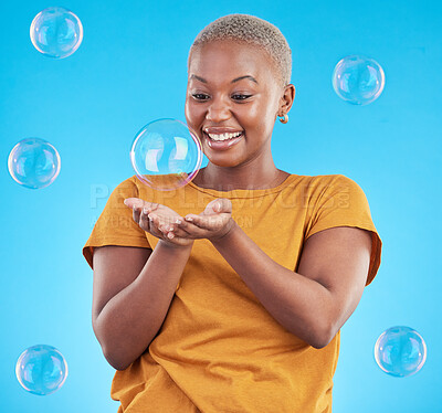Buy stock photo Black woman, play with bubbles and happiness, fun and vibrant with entertainment on blue background. Liquid soap, freedom and African female person, playful with activity and enjoy in a studio
