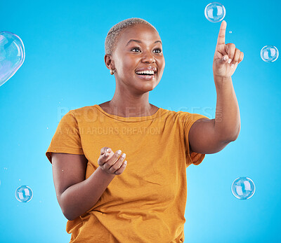 Buy stock photo Black woman, pop bubbles and happiness, fun and vibrant with entertainment isolated on blue background. Liquid soap, freedom and African female person, playful with activity and enjoy in studio