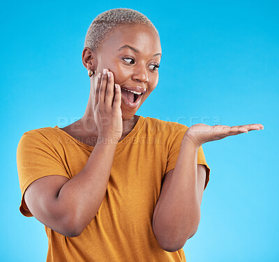 Buy stock photo Wow, mockup and promotion from a black woman on a blue background for marketing or a product. Sale, customer and an African girl or promoter with surprise and space for advertising or announcement