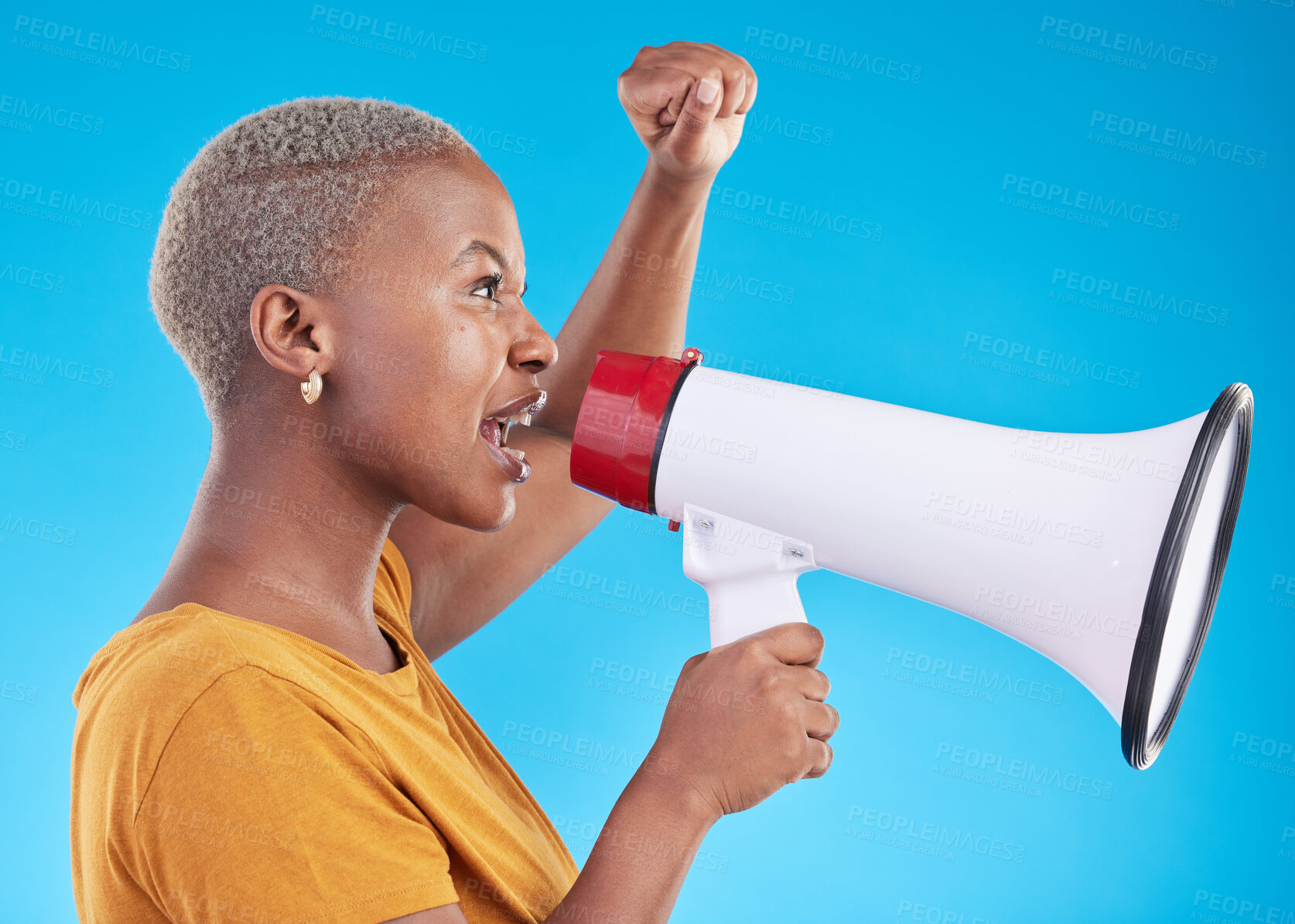 Buy stock photo Black woman, megaphone and protest in studio, shout or profile with fist in air for human rights by blue background. African gen z student, girl and audio tech for power, opinion or news announcement