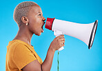 Black woman, megaphone and shout in studio, protest and profile with noise for human rights by blue background. African gen z student, girl and audio tech for justice, opinion or news announcement