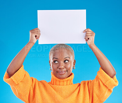 Buy stock photo Black woman, blank poster and studio with thinking, mockup space and smile with ideas by blue background. African gen z girl, student and paper billboard for promotion, branding and choice for deal