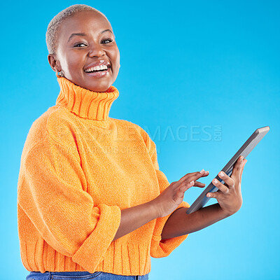 Buy stock photo Typing, portrait or black woman in studio with tablet to search social media on internet or blue background. Network, mockup space or happy person with technology for online review, news or feedback